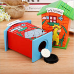 Detailed shot of the wooden piggy bank's animal cut-out design on the front.