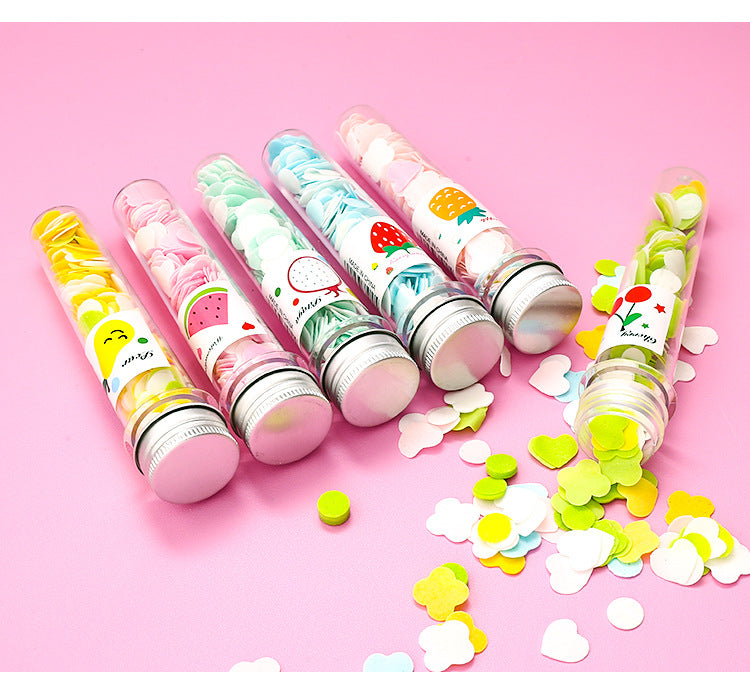 Assorted colorful flower soap strips displayed inside clear test tube