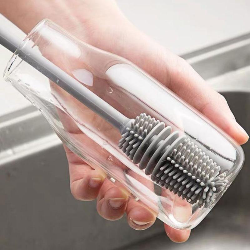 A bottle cleaning brush effectively cleaning the inside of a tall water bottle.