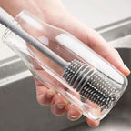 A bottle cleaning brush effectively cleaning the inside of a tall water bottle.