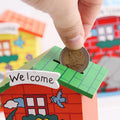 Front view of the wooden piggy bank, shaped like a charming cartoon house.