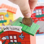Front view of the wooden piggy bank, shaped like a charming cartoon house.