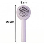 Ergonomic, non-slip handle of the Self-Cleaning Hair Brush for comfortable grip.