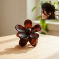 Elegant flower hair clip made of durable plastic on white background