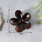 Flower hair clip resting gently on fabric surface
