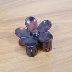 Side profile view showing flower-shaped plastic hair clip clasp