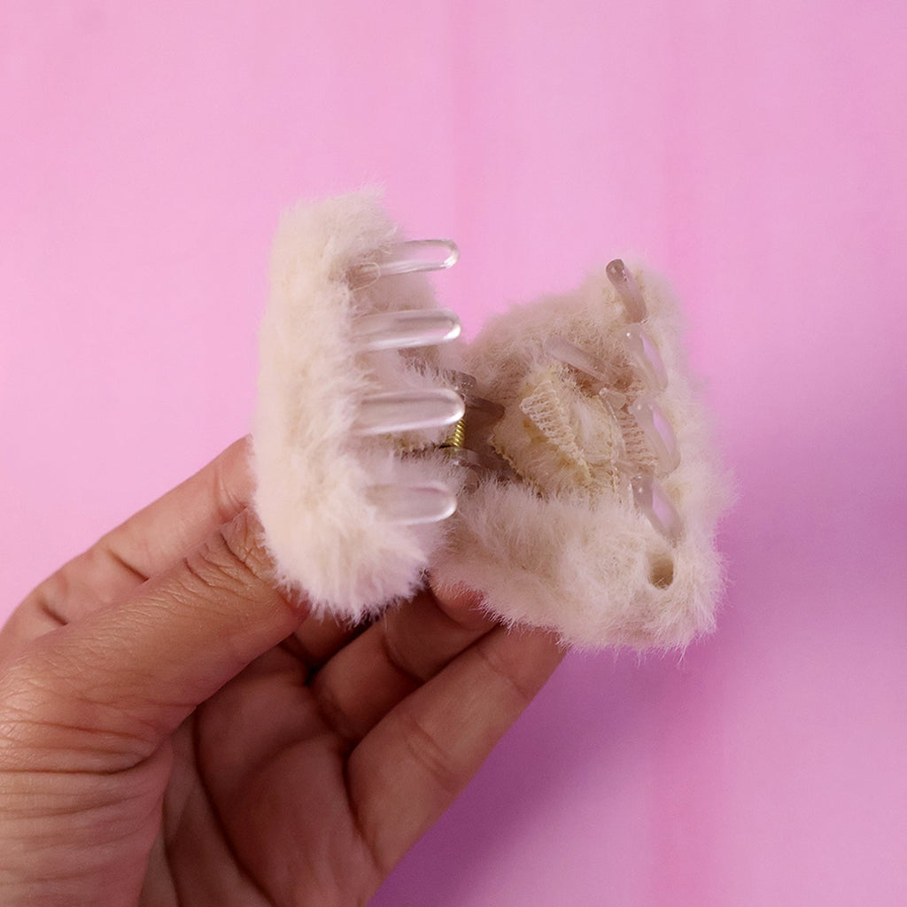 Side view of fluffy hair claw clip displaying plush grip accessory