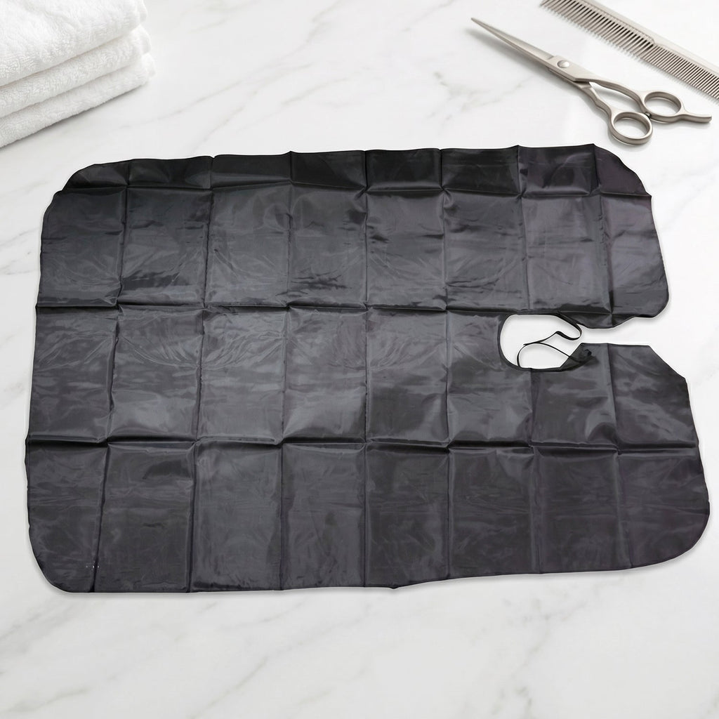 Professional hair cutting apron cape hanging on hook
