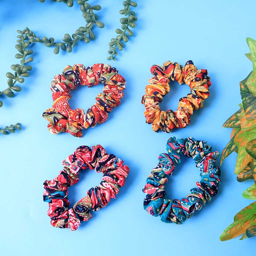 Close-up of assorted printed fabric hair scrunchies showing vibrant patterns