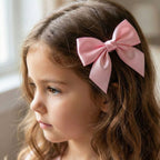 Close-up view of elegant satin fabric and metal clip of hair bow