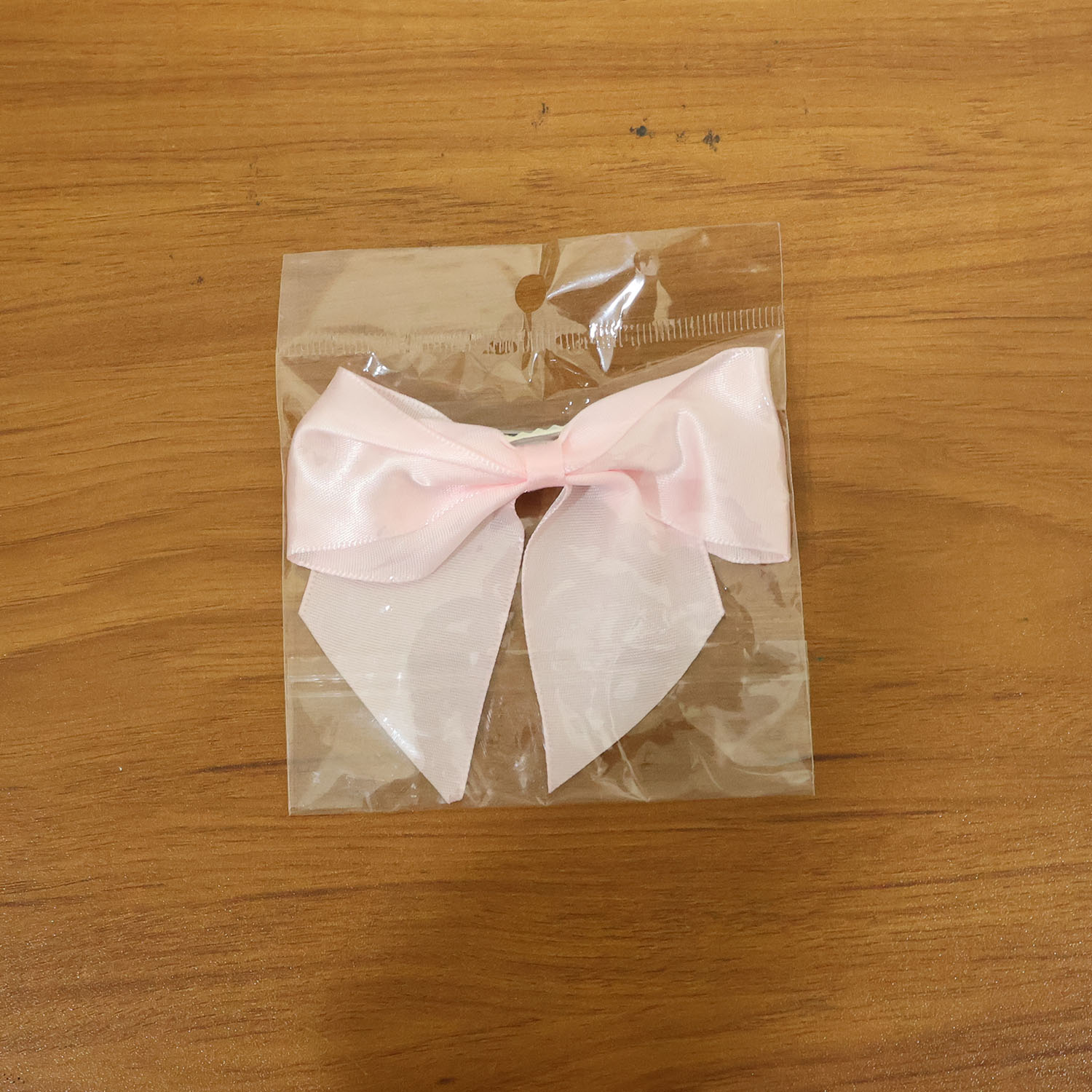 Model wearing satin hair bow clip showcasing stylish hair accessory