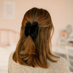 Close-up of soft faux fur hair claw clip showing sturdy plastic base and plush finish.