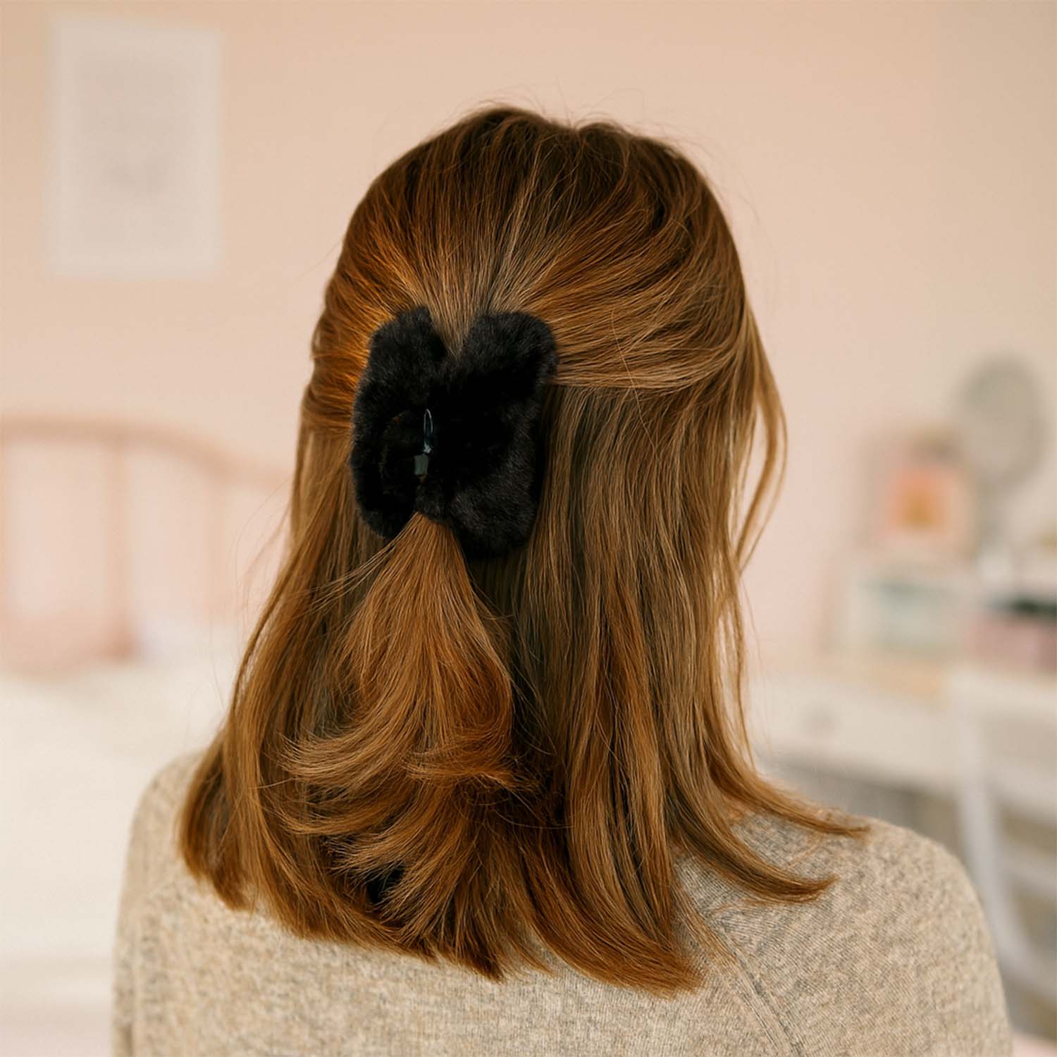 Close-up of soft faux fur hair claw clip showing sturdy plastic base and plush finish.