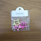 Star-shaped hair clips adorning a girl's elegant braided hairstyle.