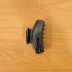 Lifestyle shot showing black hair claw clip in use on hair