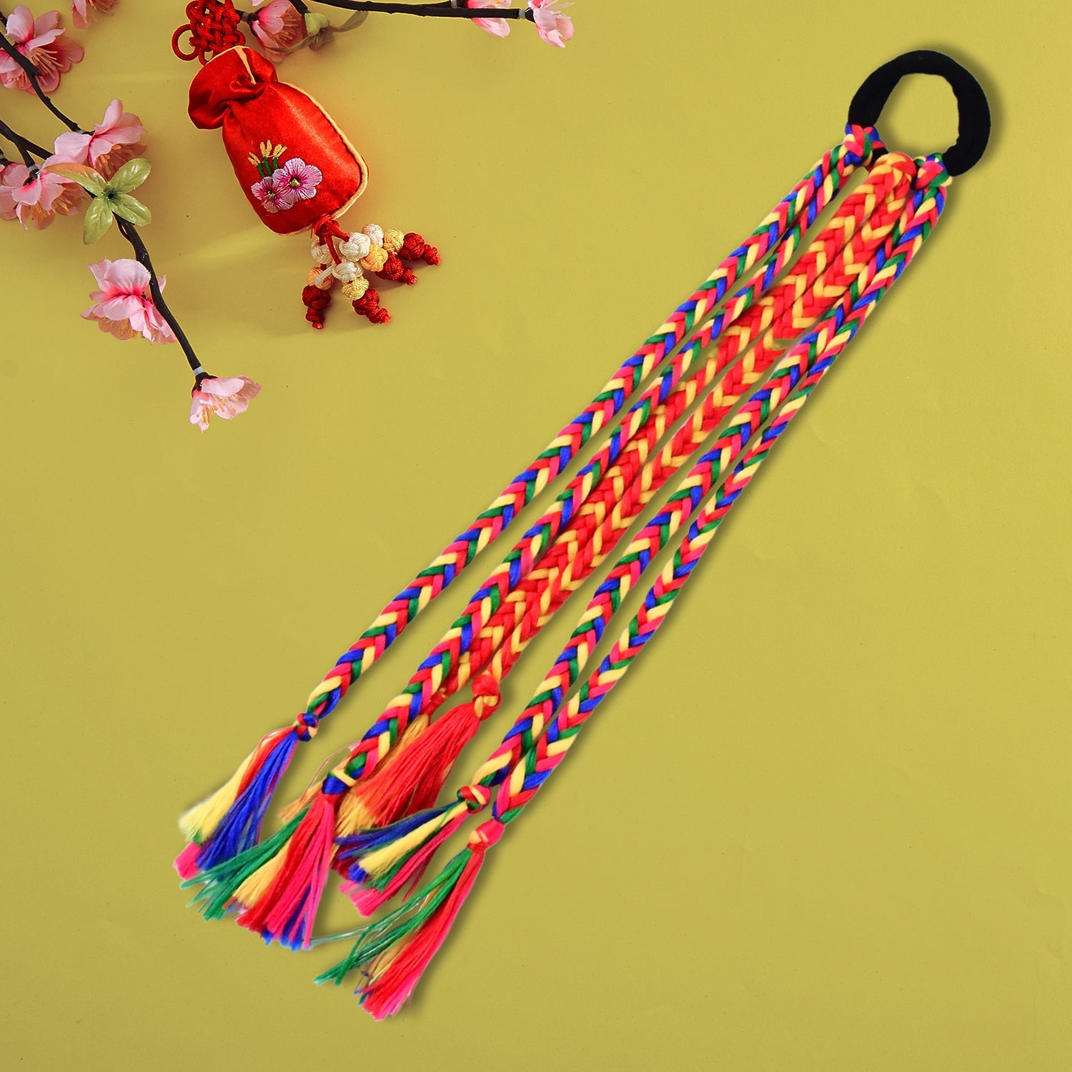 Detailed view of multicolor braided strands hair extension with tassels