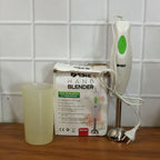 Electric hand blender in kitchen setting blending fresh ingredients
