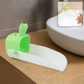 Cute bear-shaped silicone kids faucet extender on a modern bathroom sink.