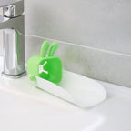 Hand demonstrating the flexible, durable silicone material of the faucet extender.