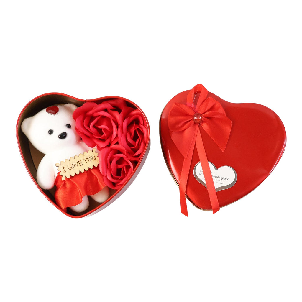 Close-up of teddy bear and scented artificial roses inside heart shaped gift box