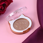 Shimmer highlighter compact open showing the powder surface