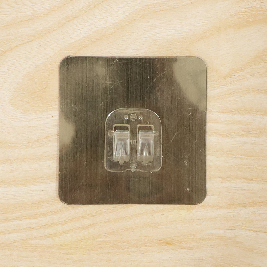 Adhesive wall hook on metal surface for home organization