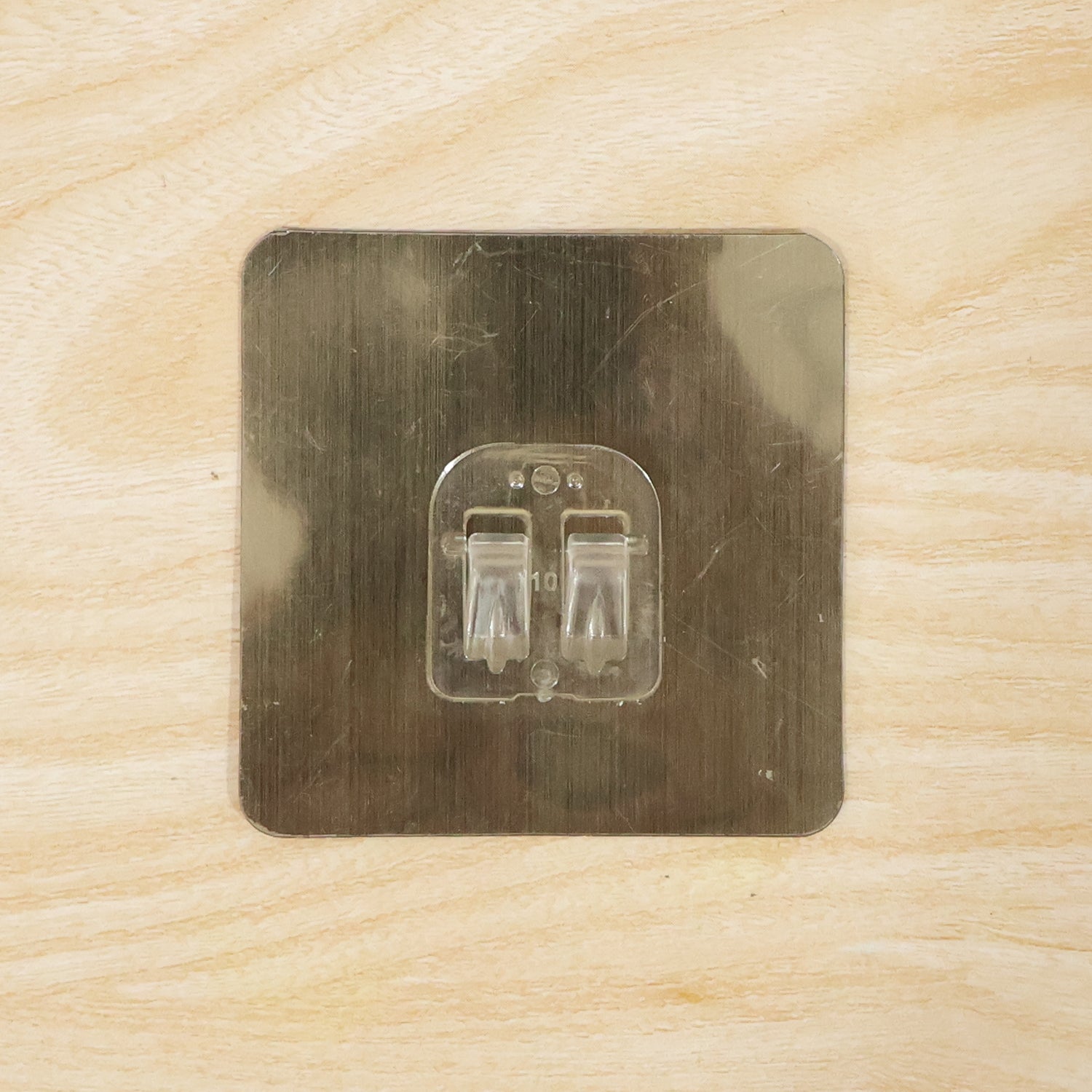 Adhesive wall hook on metal surface for home organization