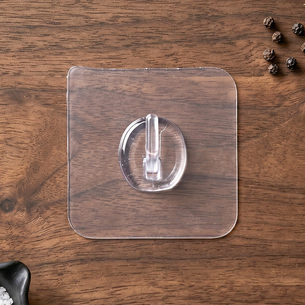 Self-adhesive clear wall hook in use for organizing small items