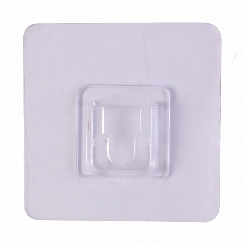Transparent wall hook attached to a smooth surface for organization.