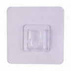 Transparent wall hook attached to a smooth surface for organization.