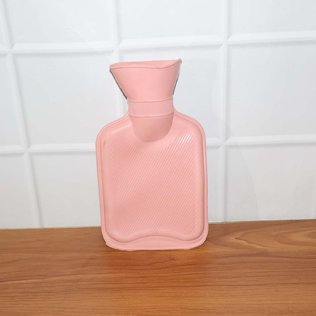 Small hot water bag in use for warm compress and pain comfort