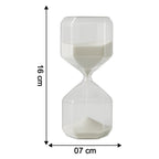 Close-up of glass timer with fine white sand flowing inside for precise visual countdown