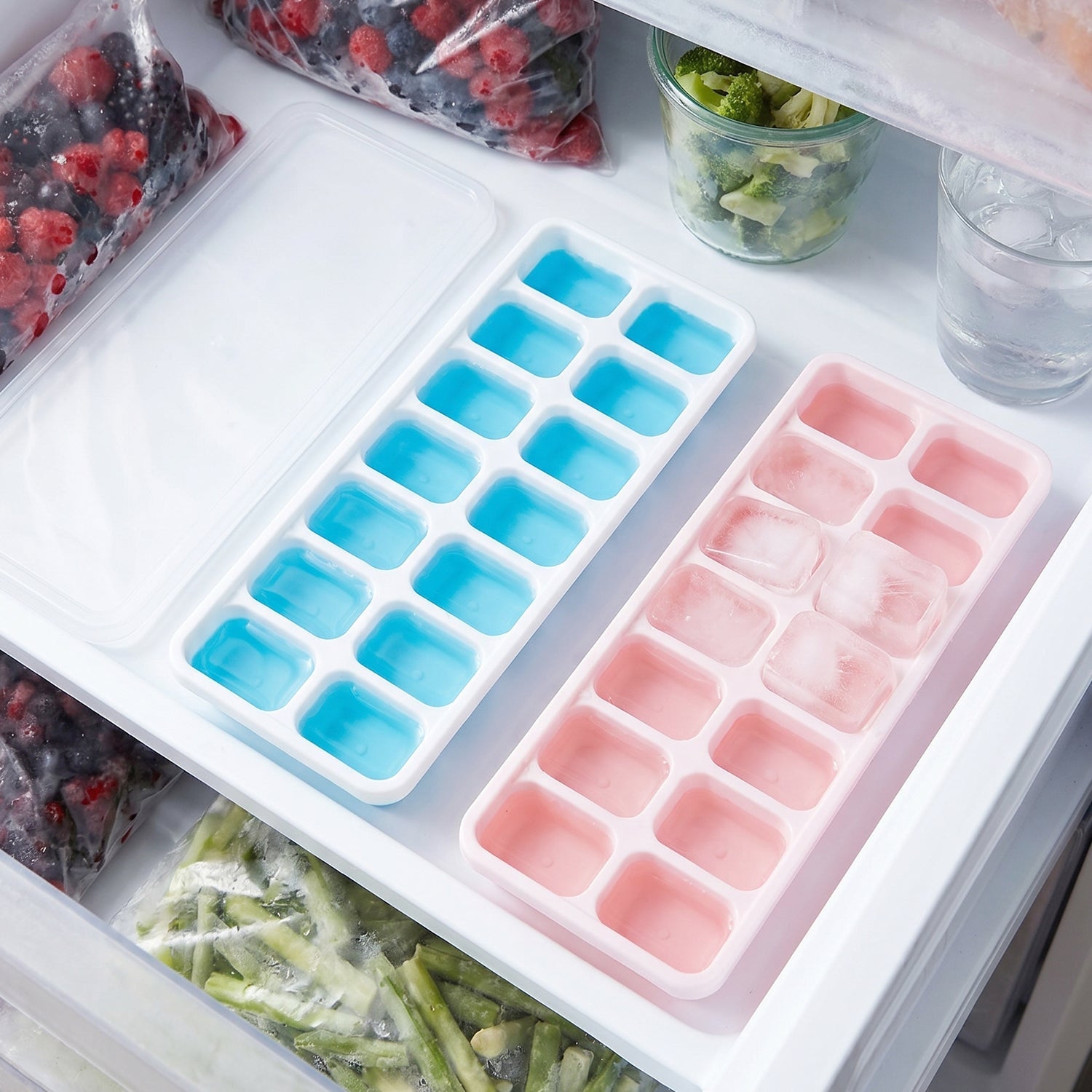 Colorful plastic ice cube trays stackable in freezer