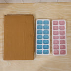 Set of two plastic ice cube trays with lids for versatile use
