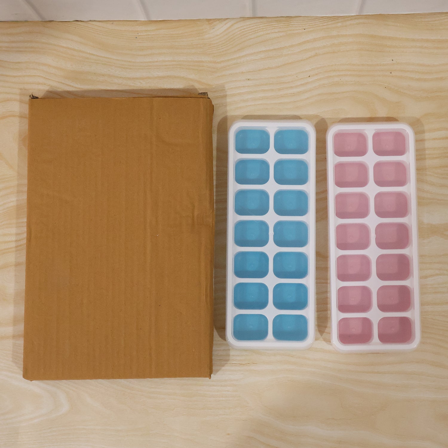 Set of two plastic ice cube trays with lids for versatile use