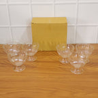 Complete set of six brown plastic serving dessert bowls ready for use.