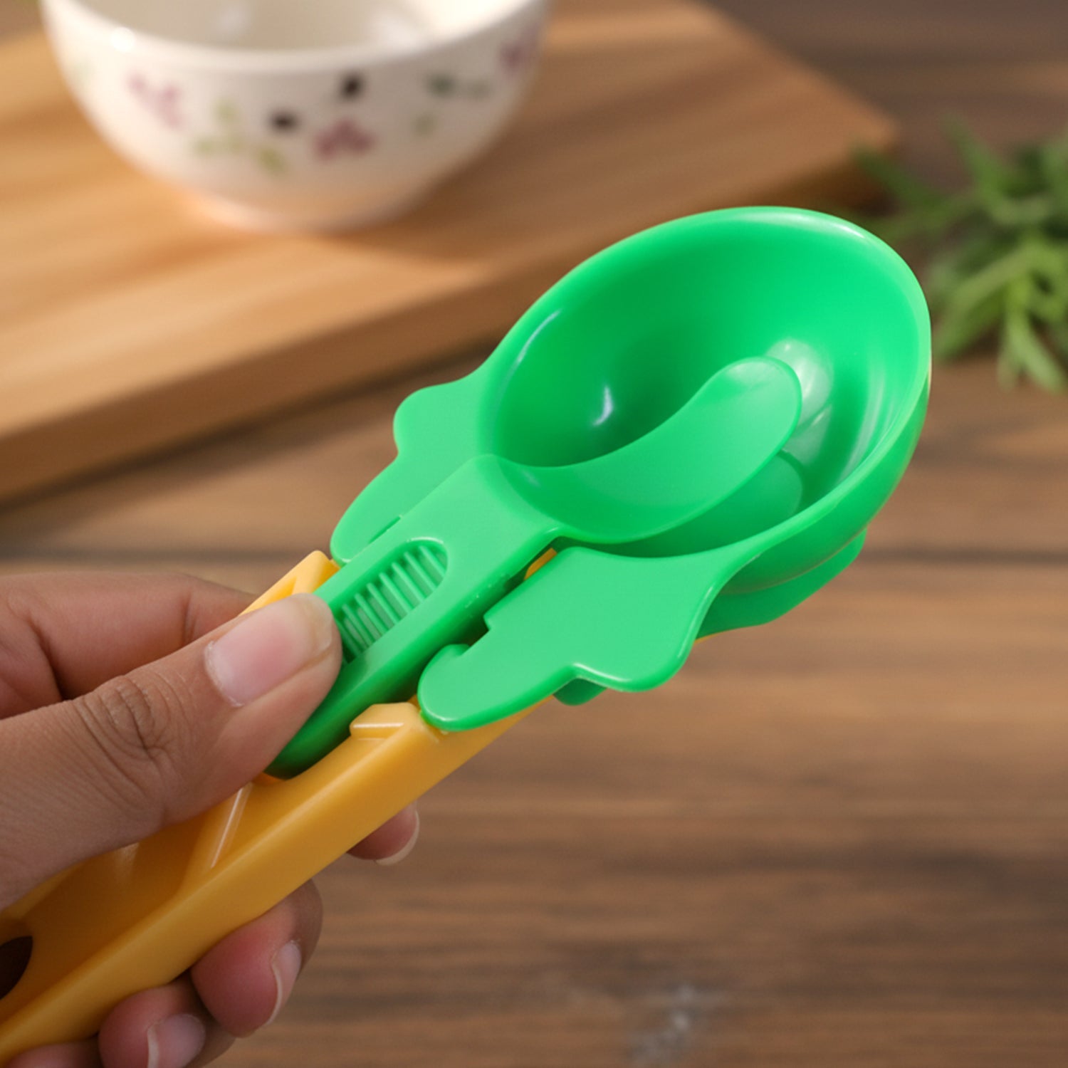 Ice cream scooper with ergonomic handle and a vibrant red scoop.