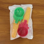 Two plastic ice cream scoops displayed neatly on a white surface.