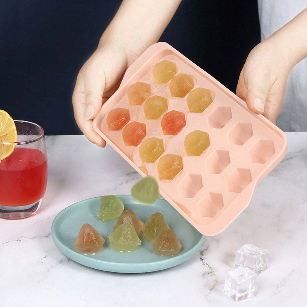 Frozen diamond-shaped ice cubes popped out of plastic tray