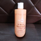 Hydrating body wash bottle resting on a bathroom surface