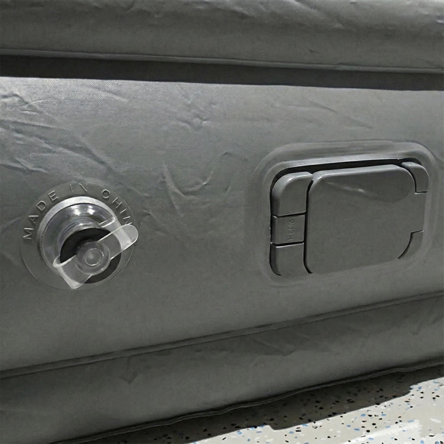 Portable inflatable bed partially folded illustrating compact and lightweight design