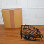 Iron shower caddy corner discreetly installed in a contemporary living space, offering utility.