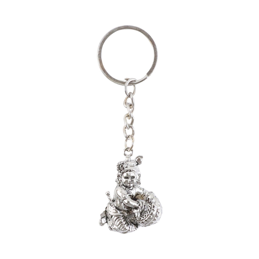 Bal Krishna Makhan Chor keychain displayed against a wooden backdrop