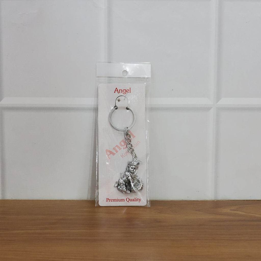 Bal Krishna Makhan Chor keychain attached to vehicle keys adding a spiritual charm