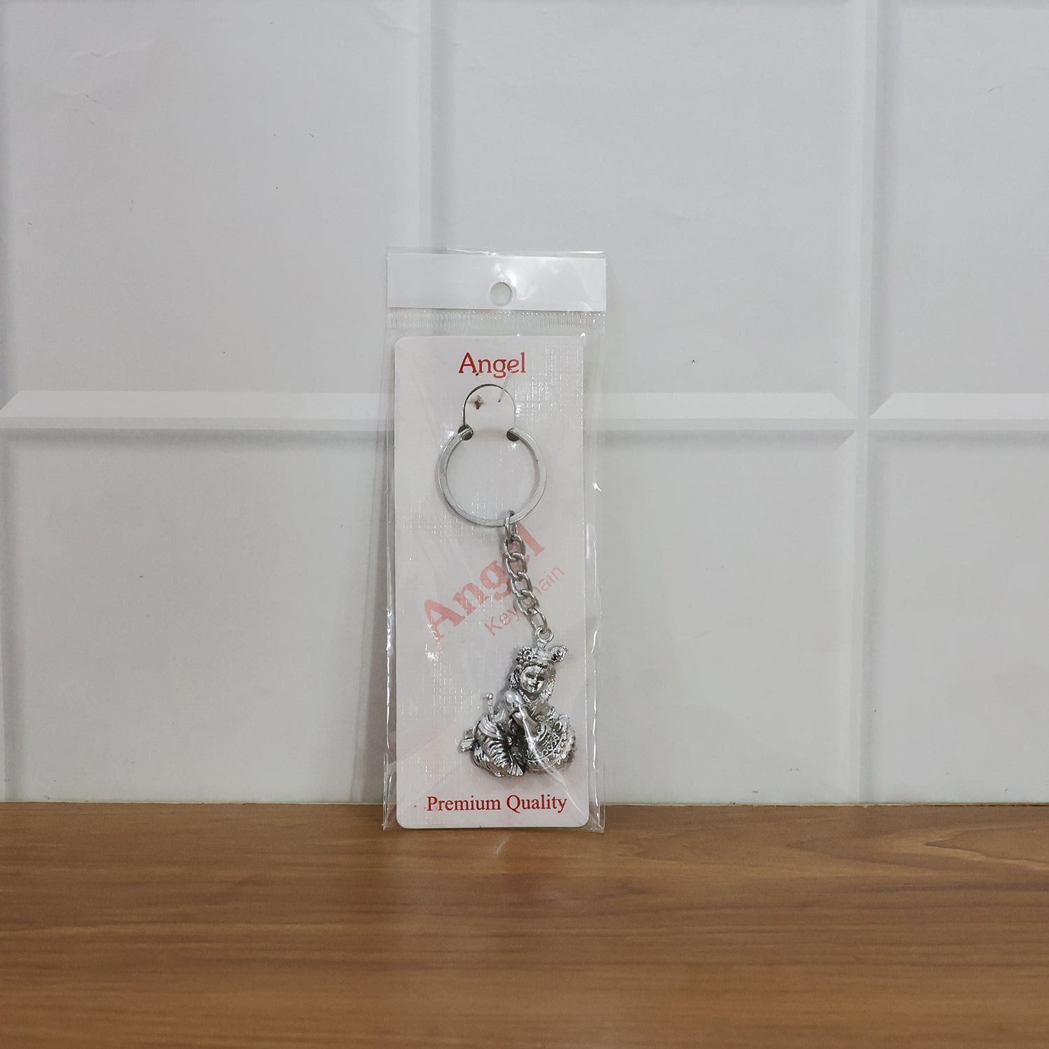 Bal Krishna Makhan Chor keychain attached to vehicle keys adding a spiritual charm