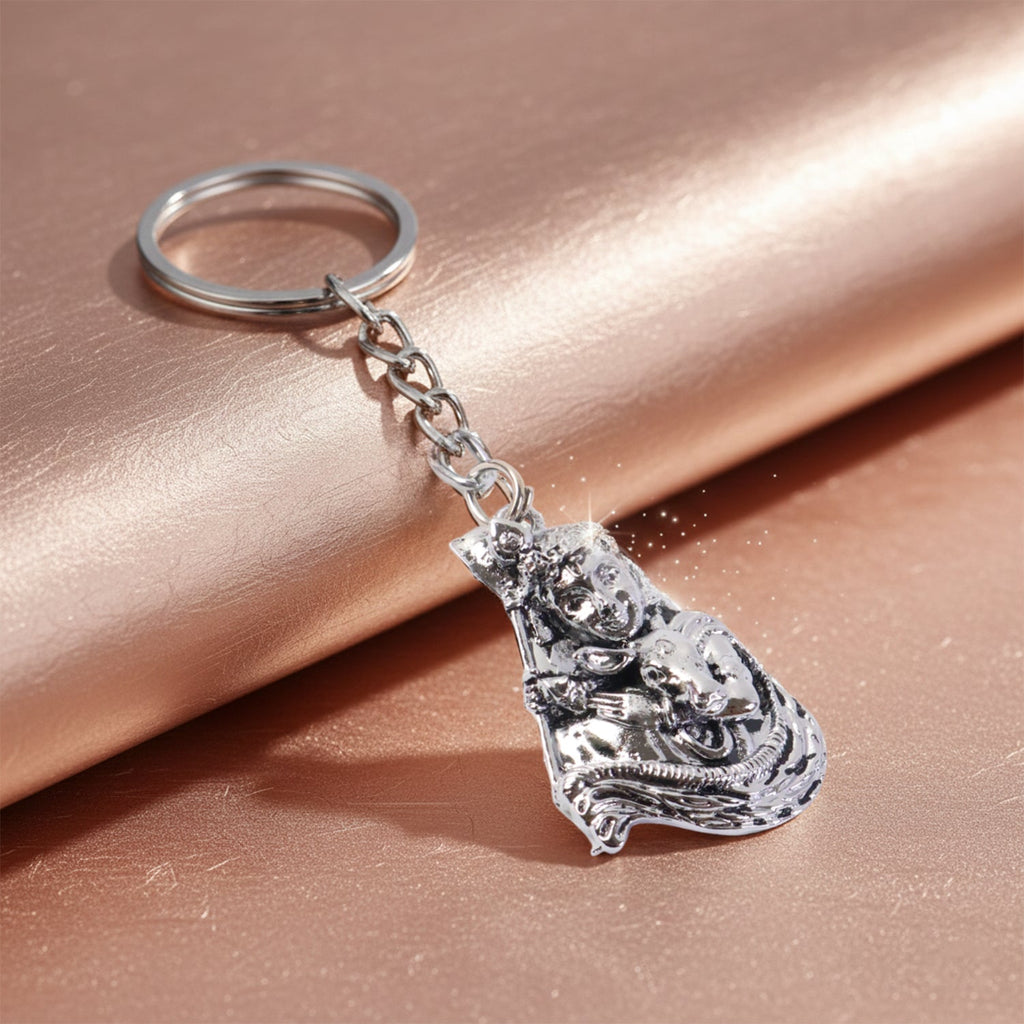 Side angle of silver finish metal keychain with Bal Krishna idol, showing lightweight design