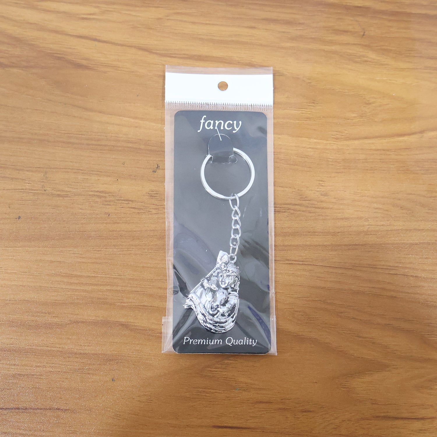 Lifestyle image of silver finish Bal Krishna keychain attached to car keys