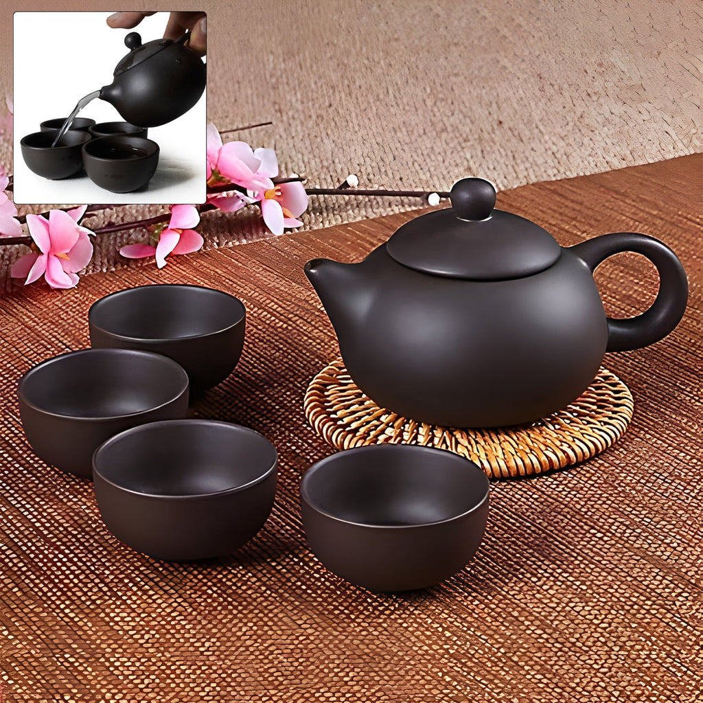 Elegant ceramic tea set with teapot and cups in matte black finish