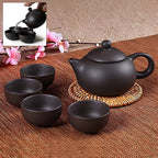 Elegant ceramic tea set with teapot and cups in matte black finish