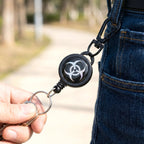Safety retractable keychain clipped on a belt loop with keys attached.
